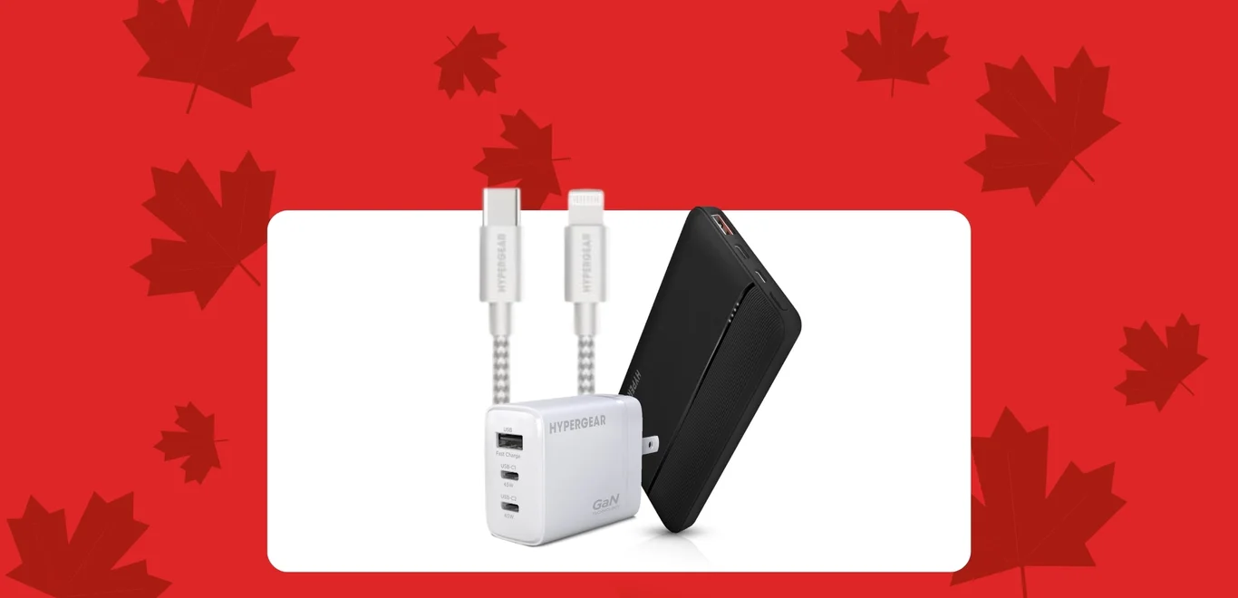 Hypergear cables inside a box behind a black Hypergear powerbank next to a white Hypergear phone charging block inside a white container against a red background covered in dark red maple leaves.